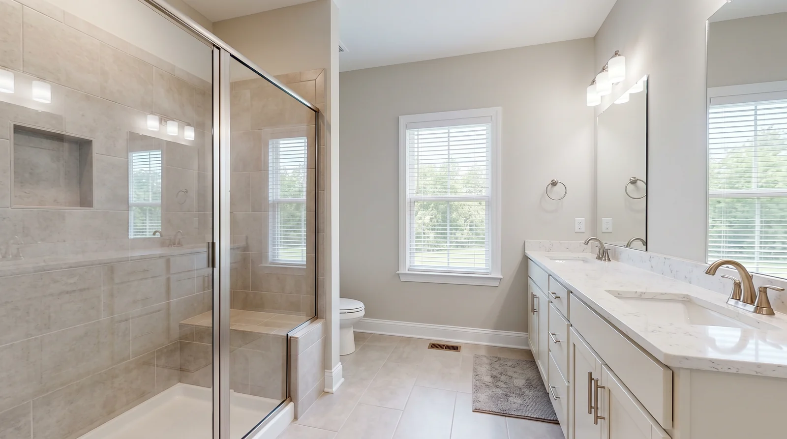 New Construction Bathroom With a Fresh Glass Enclosure | Music City Shower Doors A brand-new builder-finished bathroom in a new Tennessee home with a fresh semi-frameless glass shower door, neutral tile, a quartz vanity top and bright clean light