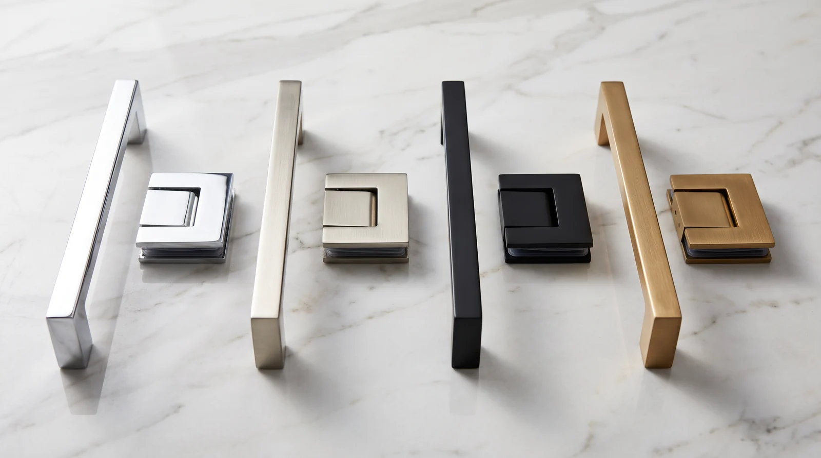 Four shower door handles and hinges lined up on a white marble surface in polished chrome, brushed nickel, matte black and brushed brass finishes, soft studio light, shallow depth of field